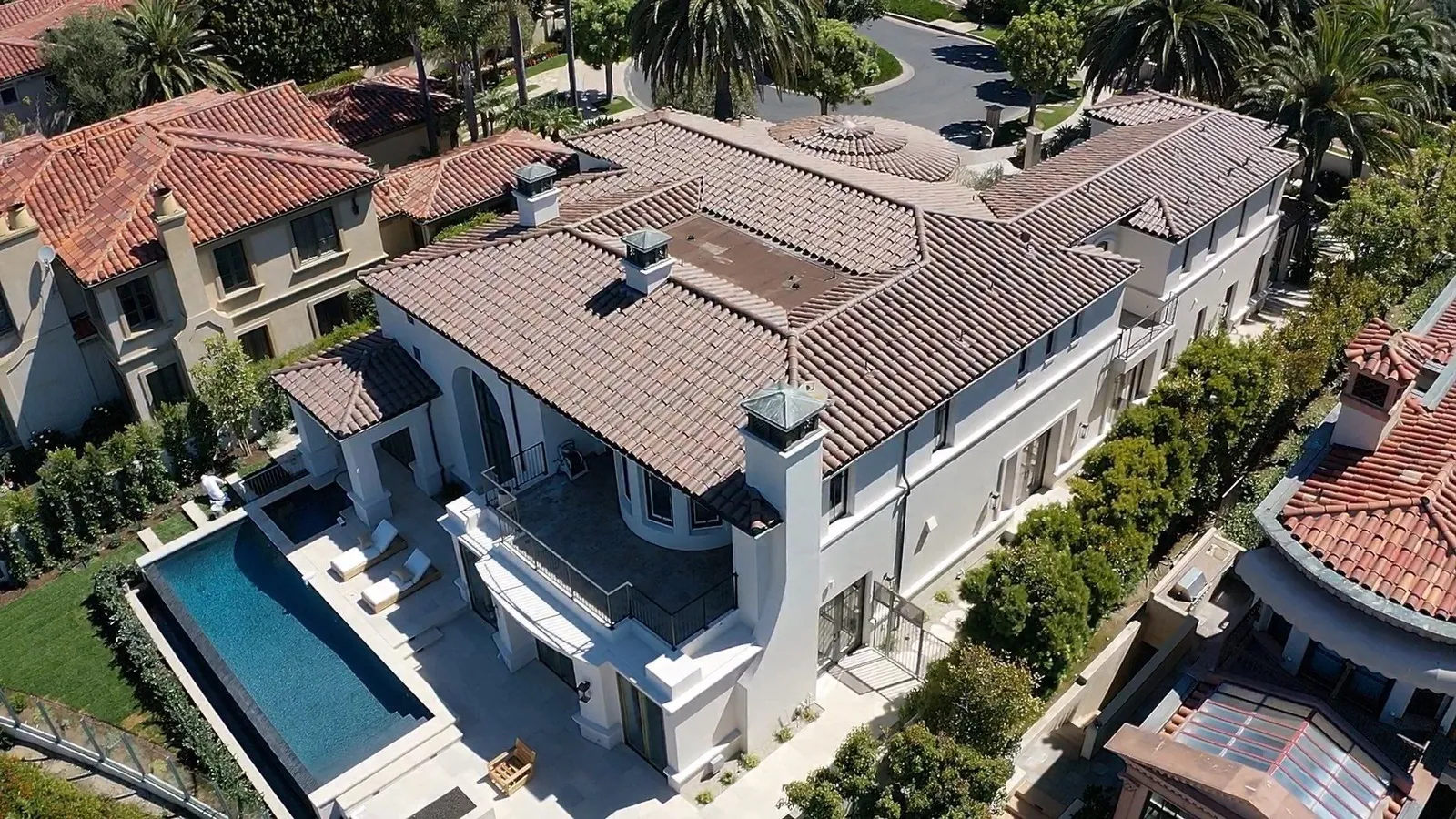 Drone view of a Mediterranean custom home with a new clay tile roof