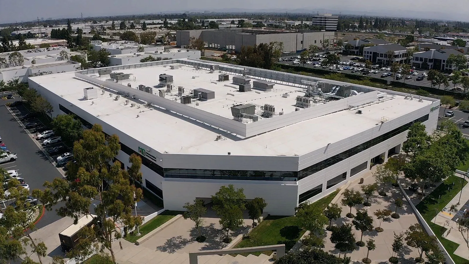 Drone view of a commercial warehouse with white single-ply roof